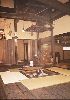 Fire place and kettle. The smoke
would rise and escape through the
raised centre section of the roof.